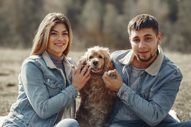 A couple having a photoshoo with their Dog.