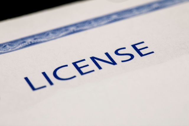 A close-up photo of a paper with a License word as heading.