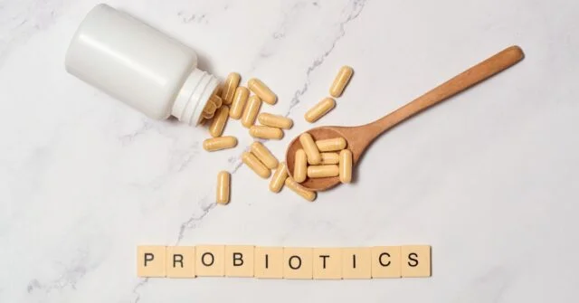 Probiotic supplement pills coming out from a bottle.